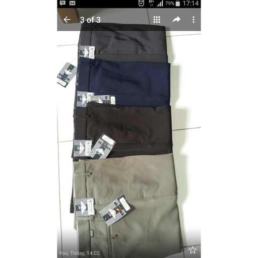 a pile of men's pants with money on them.