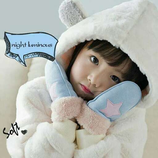 a little girl in a white bunny coat holding a phone.