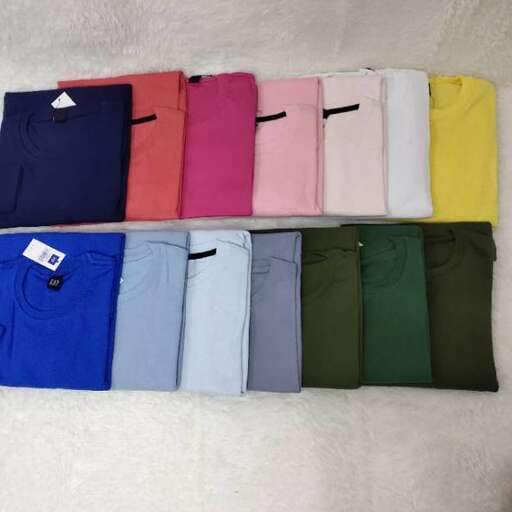 a shelf of folded shirts