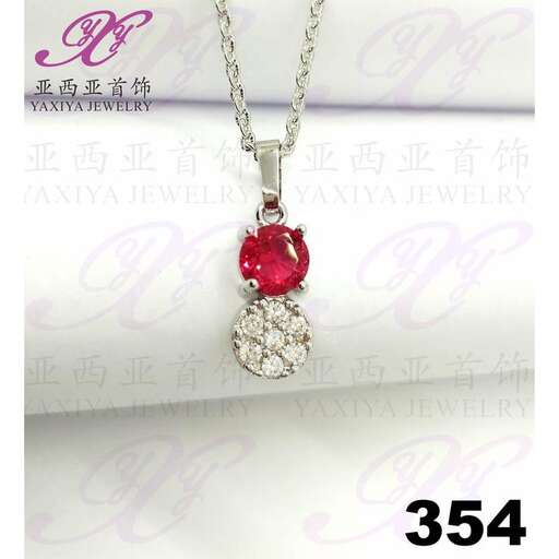 a red sapphire and diamond necklace in sterling silver with a pearl.