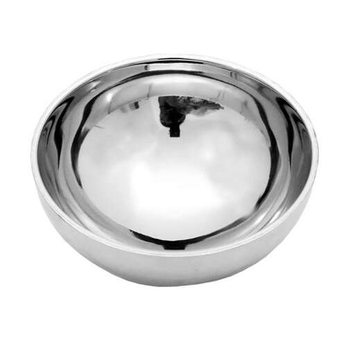 a silver bowl with a reflection of a tree in it.