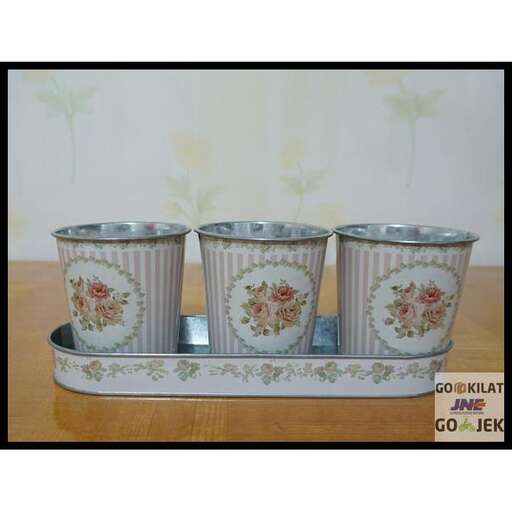 a set of three cups on a tray.