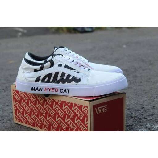 men's white vans with black laces.