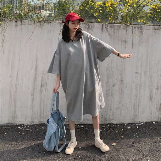 person in a gray dress and white shoes