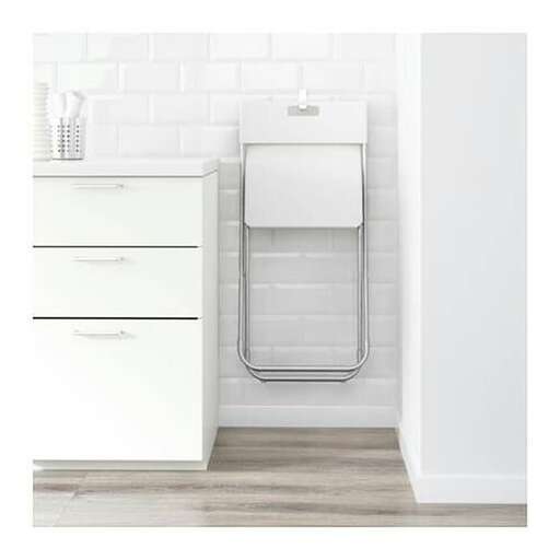 a white bathroom with a white sink and white cabinets.