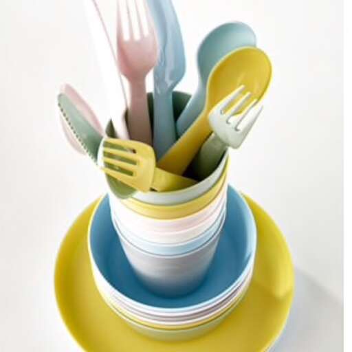 a stack of plastic forks and spoons in a bowl.