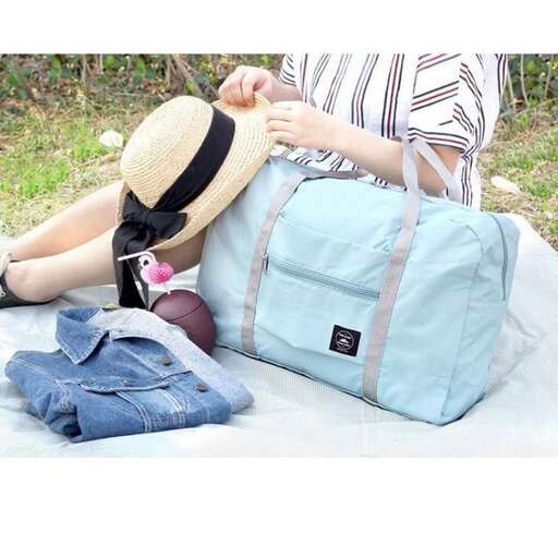 a woman is sitting on a blanket with a hat on her head.