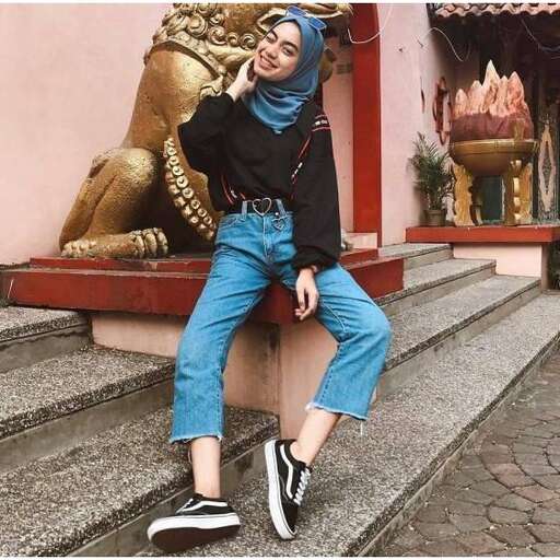 a girl in a black hoodie and jeans