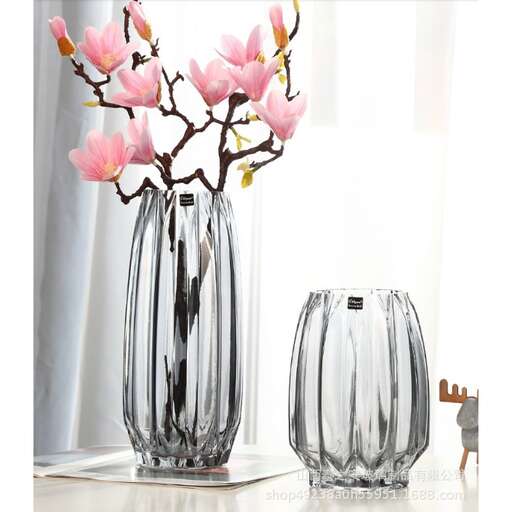 a vase with pink flowers in it on a table.