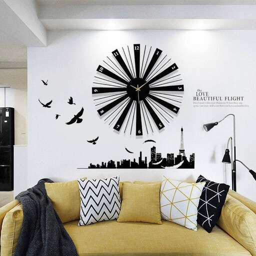 a living room with a yellow couch and a clock on the wall.