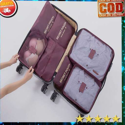 a person's hand is holding a suitcase.