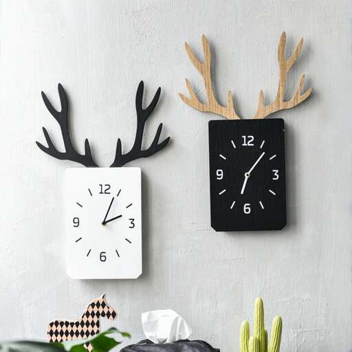 a wall with a clock and some antlers on it