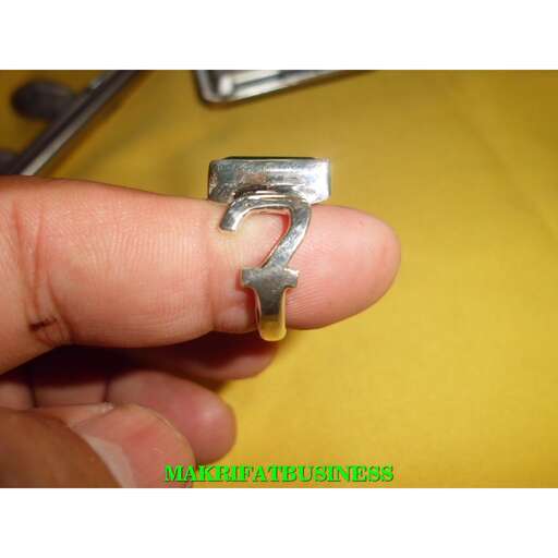 a sterling silver ring with a yellow stone in the middle.