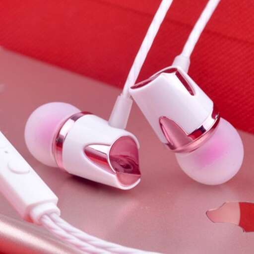 a pair of white and pink ear buds sitting on a table.
