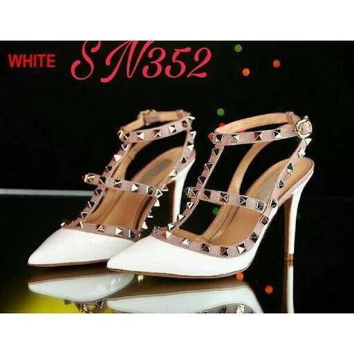 a pair of white shoes with a touch of neon