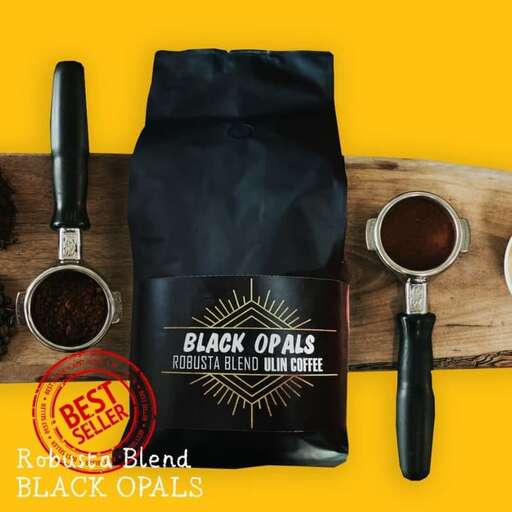 a bag of black coffee beans and a spoon.