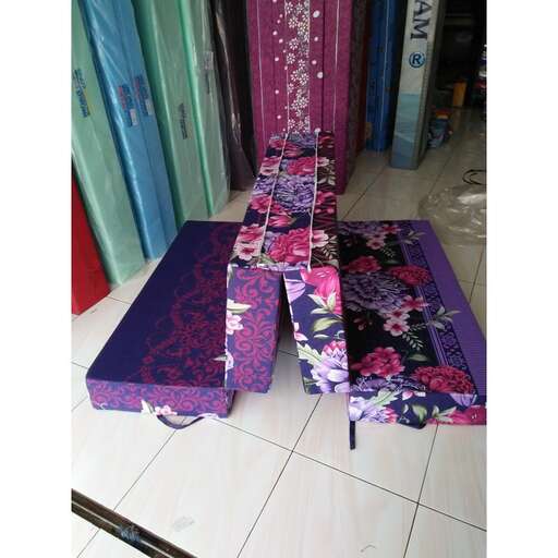 a purple ottoman with a purple mat on it.