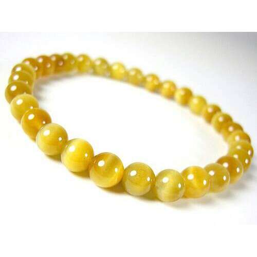 this is a bracelet made of yellow glass beads.