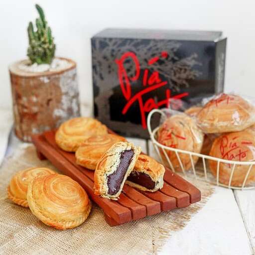 a table topped with pastries and a box of tissues.