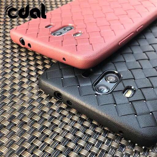 a pink cell phone sitting on top of a table.