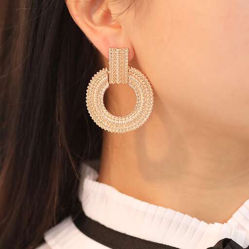 a pair of earrings with a gold hoop in the middle.