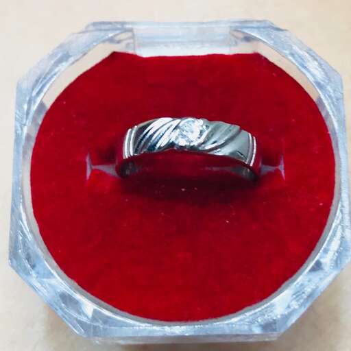 a ring in a box with a red cushion.