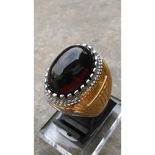 a ring made of black opal and red glass.