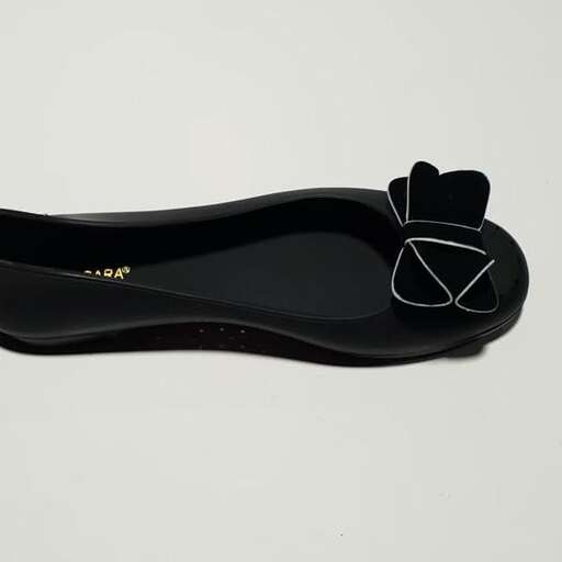 a pair of black shoes with a diamond on the front.