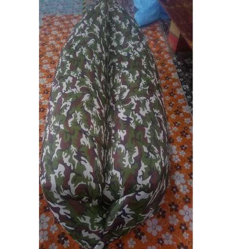 the large green floral patterned pillow is on the floor.