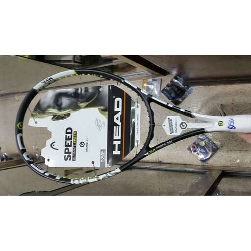 a close up of a tennis racket on a table