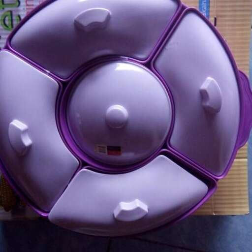 a soccer ball with a purple base is sitting on a shelf.