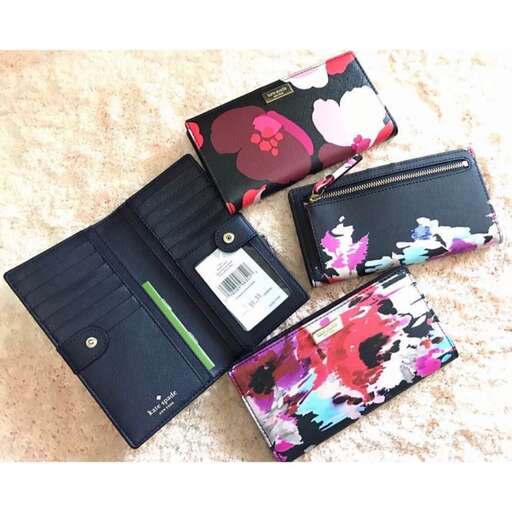 a wallet with a flower design on it and a small wallet in the middle.