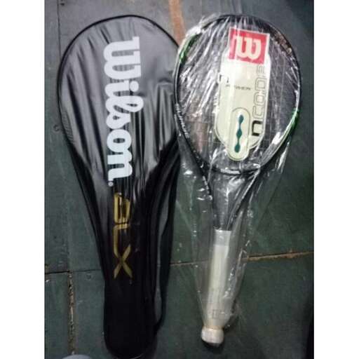 a tennis racket and a plastic bag on the ground.
