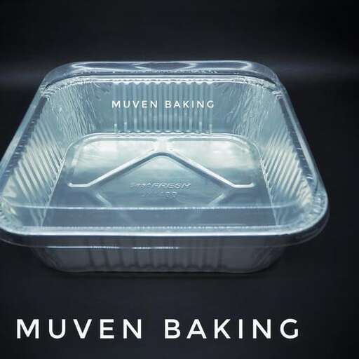 a plastic container of food is sitting on a black surface.