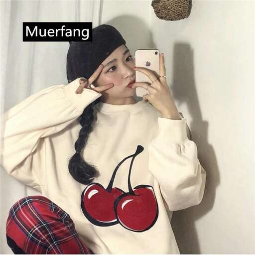 a girl in a sweater and a cell phone