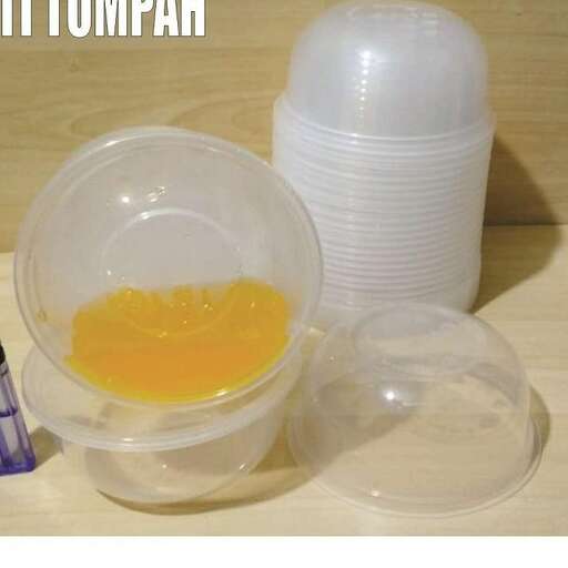 a plastic container with a plastic container and a plastic container with a bottle of orange juice.
