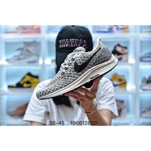 a woman is holding a shoe in her hand.