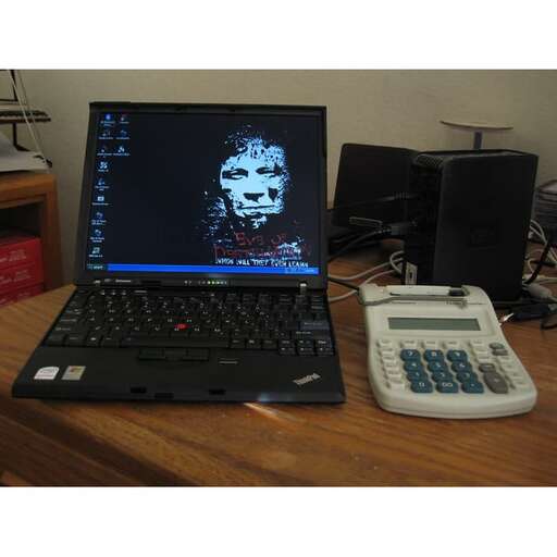 a laptop computer sitting on top of a wooden desk.