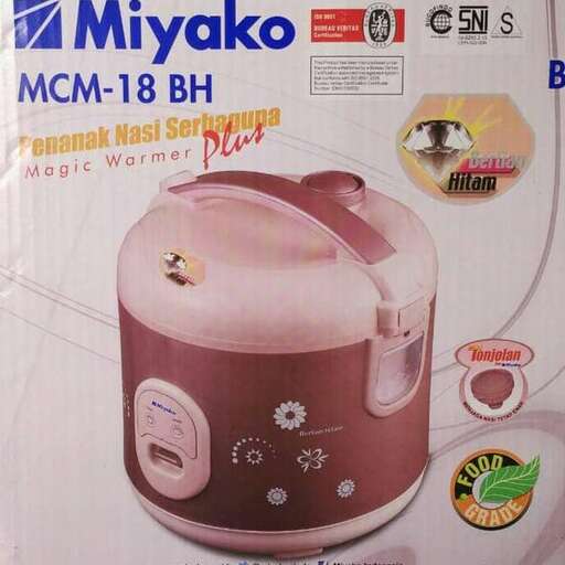 a small red crock pot on a box.
