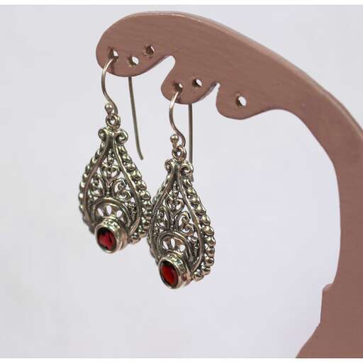 earrings made of silver and red glass with a red stone in the center.
