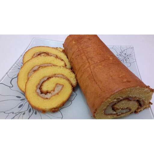 a plate with a pastry cut in half and a slice of bread.