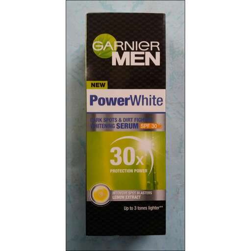 white, black and green product in a silver metal box