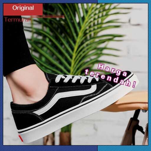 a pair of black and white sneakers with a touch of red and white.