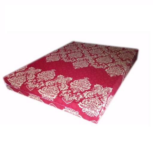 a red and white pillow with a floral pattern.