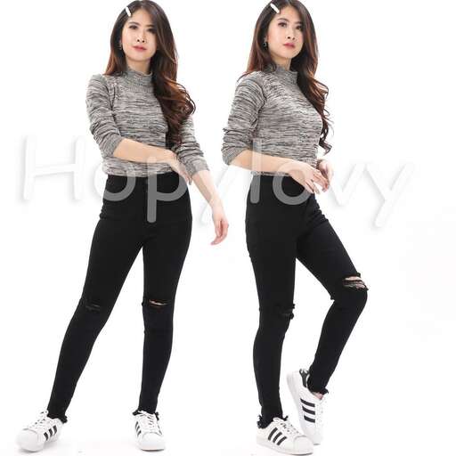 a girl in a gray sweater and black jeans
