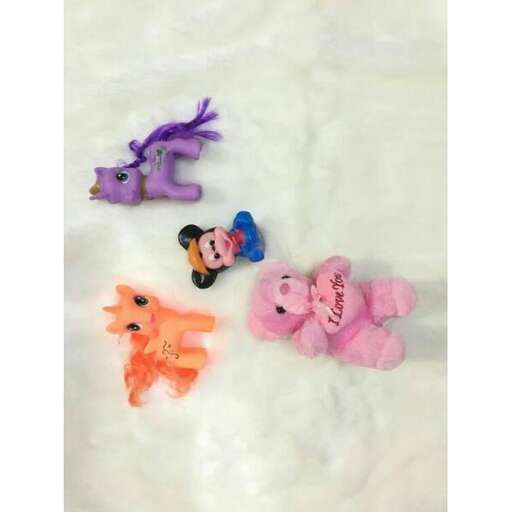 a group of stuffed animals laying on a blanket.