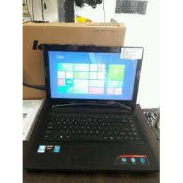 a black laptop computer sitting on a table.