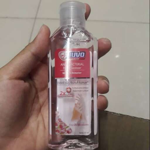 a hand holding a bottle of water.