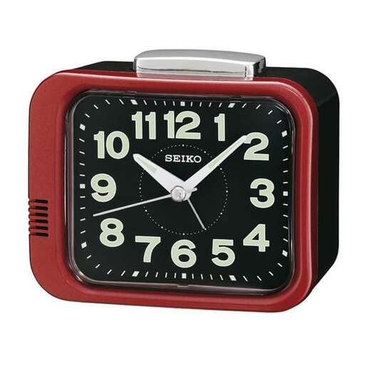 a red clock with a black face and a white face.