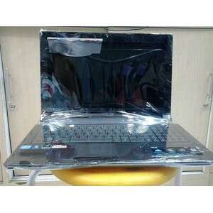 a laptop computer sitting on a yellow stool.